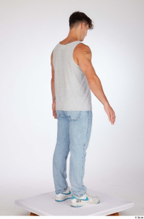 Darren a-poses blue jeans casual dressed grey tank top standing…